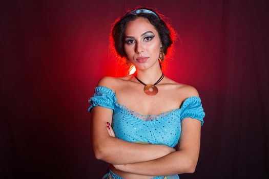 Portrait of a young woman in the image of an Eastern fairy Princess on dark background