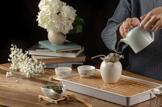 tea table with instruments teapots cups and green tea cooking process