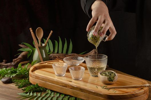 the tea table with instruments teapots cups pancake and tea Shen Puer