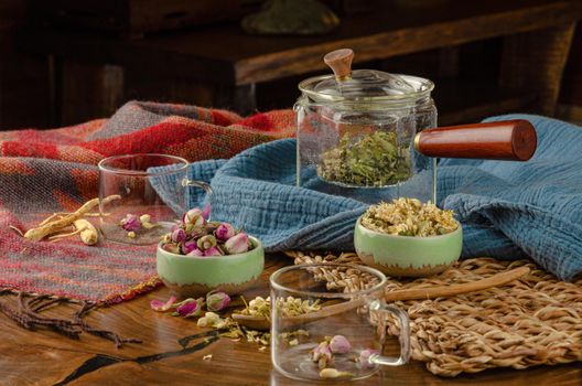 table with herbal tea and rose petals