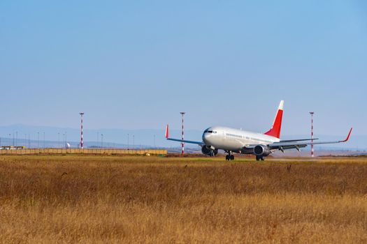 Passenger plane taking off from runway at airport on sunny day photo
