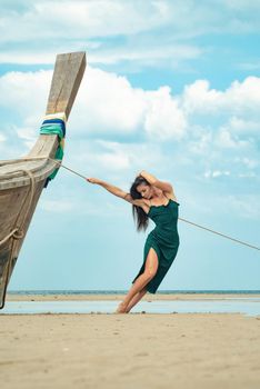 the photo of a charming brunette long-haired woman on the ocean. Fashion and glam concept. Copy space