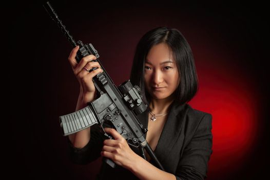 the asian woman in a jacket with an automatic rifle in her hands mafia fighter