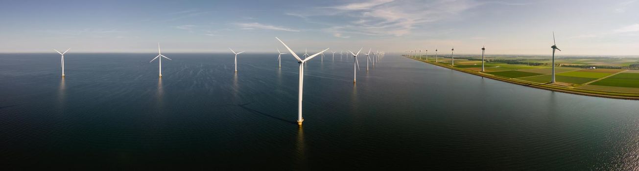 Wind turbine from an aerial view, Drone view at windpark a windmill farm in the lake IJsselmeer the biggest in the Netherlands, Sustainable development, renewable energy. 