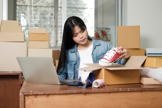 Online small business owner. Young startup entrepreneur online small business owner working at home, packaging and delivery situation. 