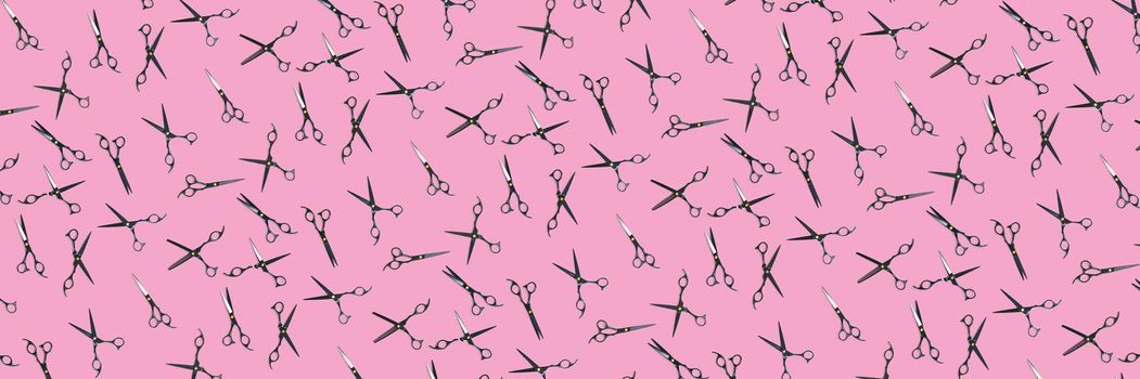 Background of black scissors. professional hairdresser black scissors isolated on pink. Black barber scissors, close up. pop art background, for prints or posters. not seamless pattern