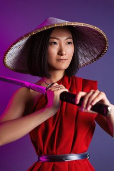 the portrait of an Asian woman in a red cape and an Asian hat with a katana in her hand image of a samurai