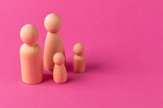 Wooden little figures of people close up. Family concept