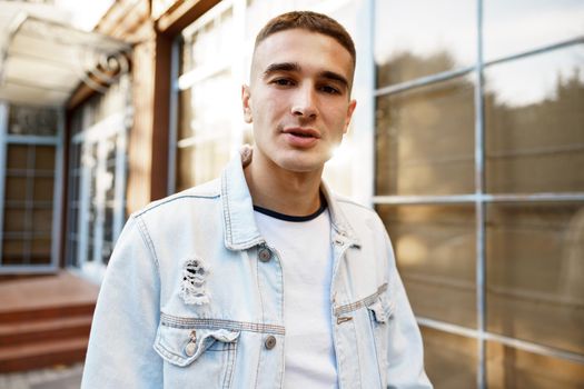 Portrait of handsome young casual man walking on the city street