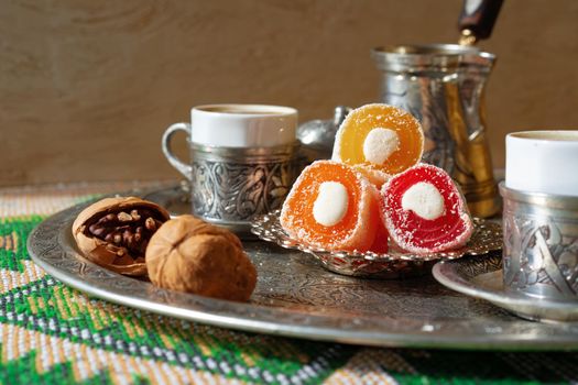 Turkish Coffee served with Turkish Delight on metal tray, close up