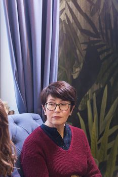 pretty brunette middle aged woman at cafe.