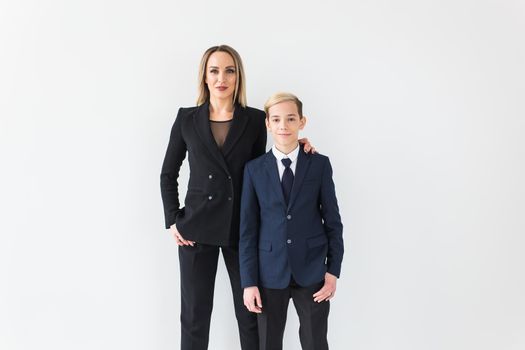 Teenager and single parent - Young mother and son standing together on white background