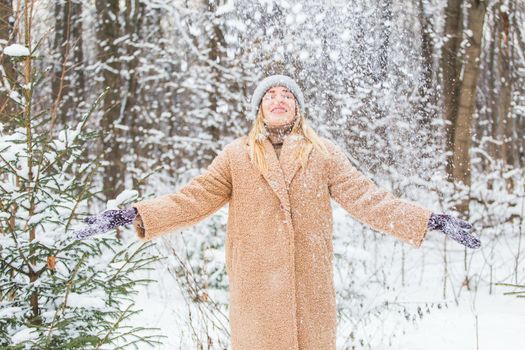 Woman throws up snow, fun and winter.