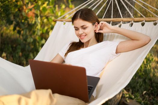 woman love with laptop on nature vacation work travel. High quality photo
