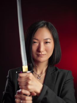 the asian woman in a jacket with a katana in her hands mafia fighter emotions on her face