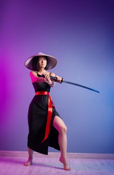 the slender Asian woman an Asian hat with a katana in her hand image of a samurai
