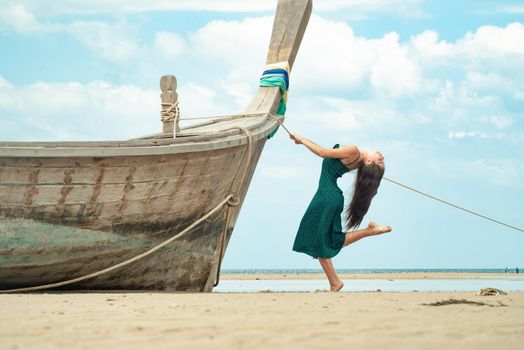 the photo of a charming brunette long-haired woman on the ocean. Fashion and glam concept. Copy space