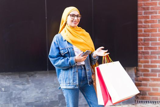 Happy arab muslim girl with shopping bags after mall