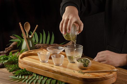 the tea table with instruments teapots cups pancake and tea Shen Puer