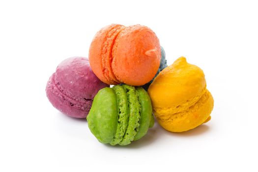 Pile of colorful meringue cookies isolated on white background