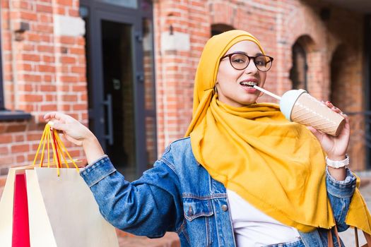 Happy arab muslim girl with shopping bags after mall