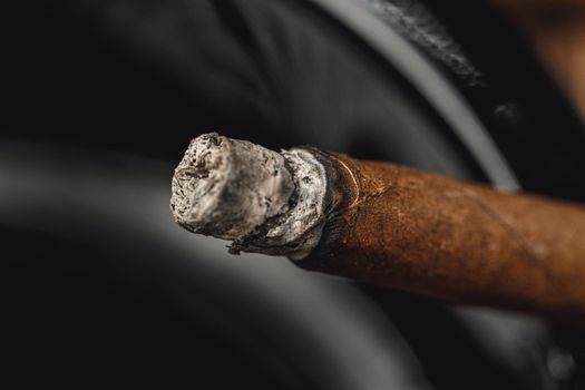 Lighted cigar in an ashtray close up. Smoking concept