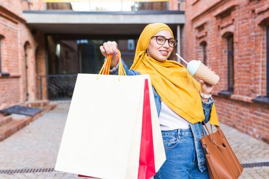 Happy arab muslim girl with shopping bags after mall