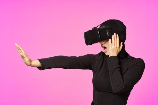 muslim woman wearing virtual reality glasses entertainment technology device. High quality photo