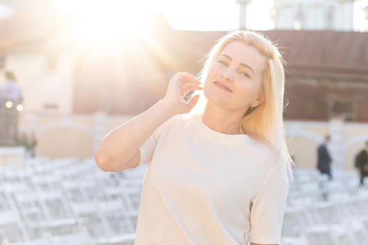 an empty concert hall, woman near empty chairs at concert