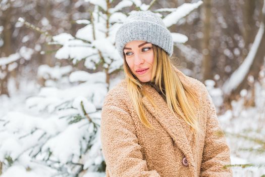 Attractive young woman in winter time outdoor. Snow, holidays and season.