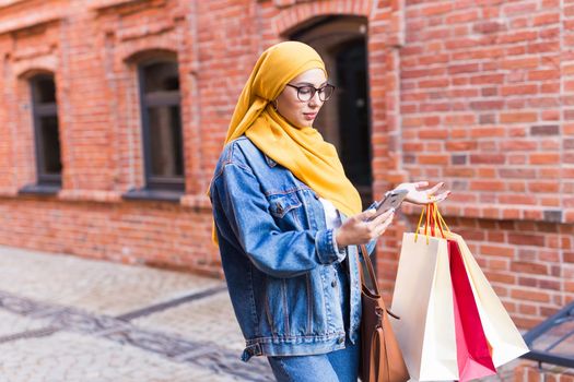 Happy arab muslim girl with shopping bags after mall