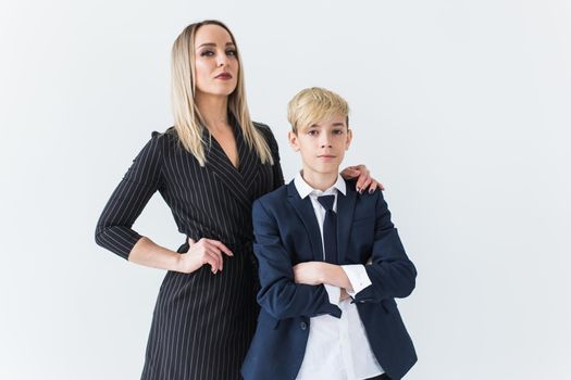 Teenager and single parent - Young mother and son standing together on white background