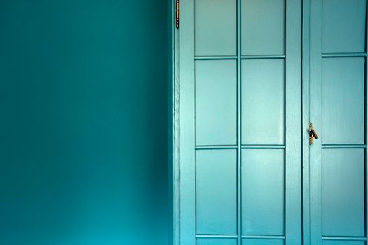 Cyan blue wall with cupboard stylish interior,modern blue cupboard door background texture beautiful luxury house decoration closeup