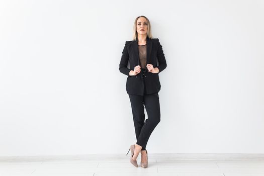 Fashion concept - Portrait of sexy business woman in a suit on white.