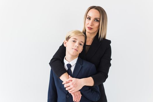 Parenting, family and single parent concept - A happy mother and teen son smiling on white.