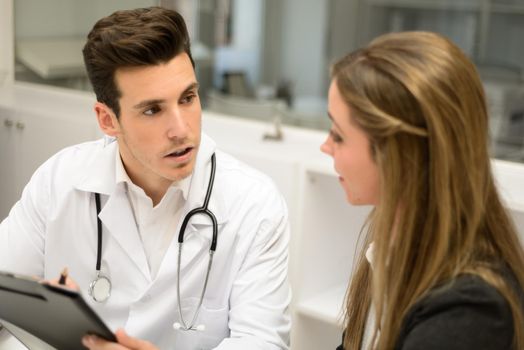Portrait of a doctor listening to patient explaining her painful in his office