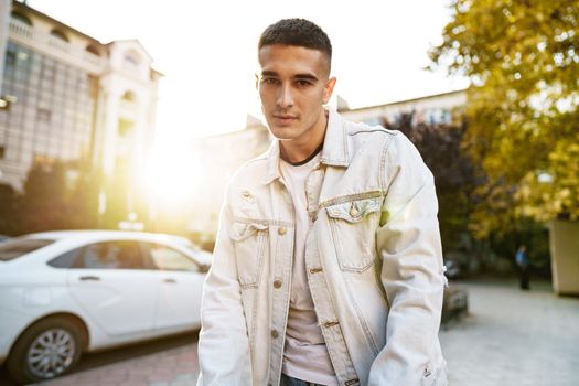 Portrait of handsome young casual man walking on the city street