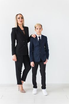 Teenager and single parent - Young mother and son standing together on white background