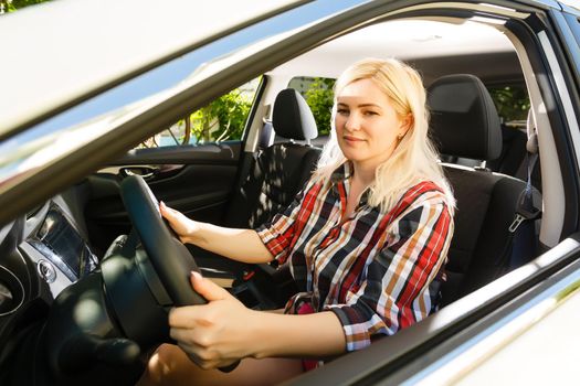 Young woman driving her car