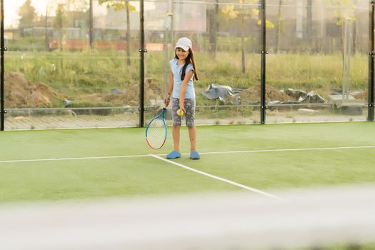 Nice girl with racket in hands playing game of tennis