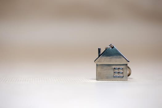 Little miniature house on blurred background, New home, Real Estate, Mortgage loan,architectural concept with Copy space space fot text