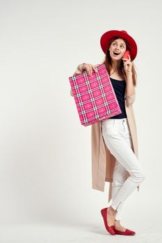 cheerful woman wearing a red hat posing shopping fun light background. High quality photo