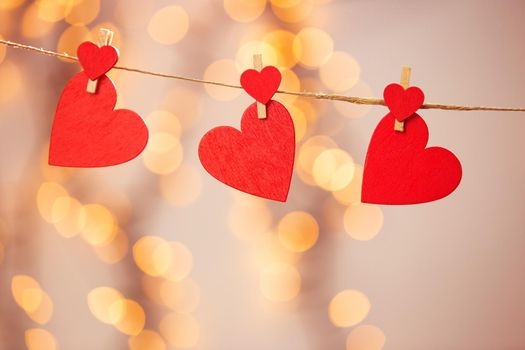 Happy Valentine day background with red hearts hang with clothespin on rope with bokeh background, romantic design, greeting card or copy space space for text