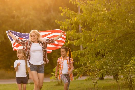 Family Posing Outdoors With American Flag