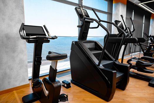Modern gym interior with new fitness equipment, no people