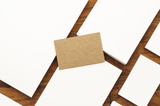 Blank businesscard stacks on rough wooden table, copy space
