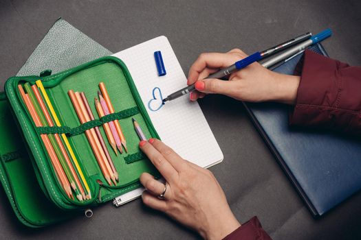 green pencil case with pencils design object school supplies. High quality photo