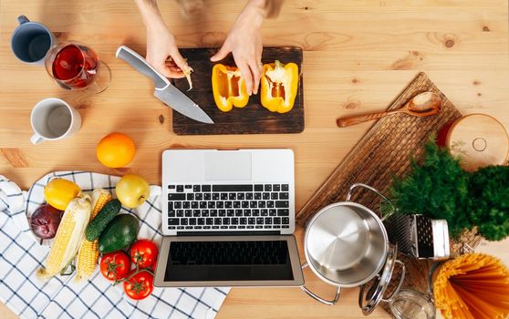 Unrecognizable woman cooking vegetables in her kitchen close up