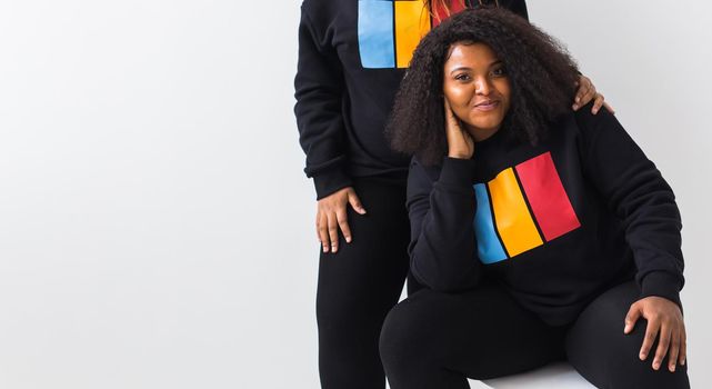 Happy African American woman and man have relationships, toothy smile, happy to meet with friends, dressed casually on white background. Emotions and friendship