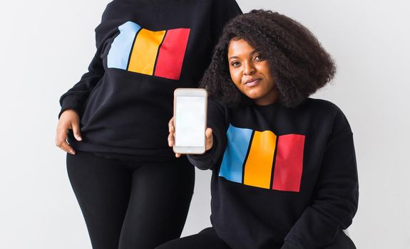 Modern Technology Concept. African american woman showing blank phone screen, mockup, selective focus